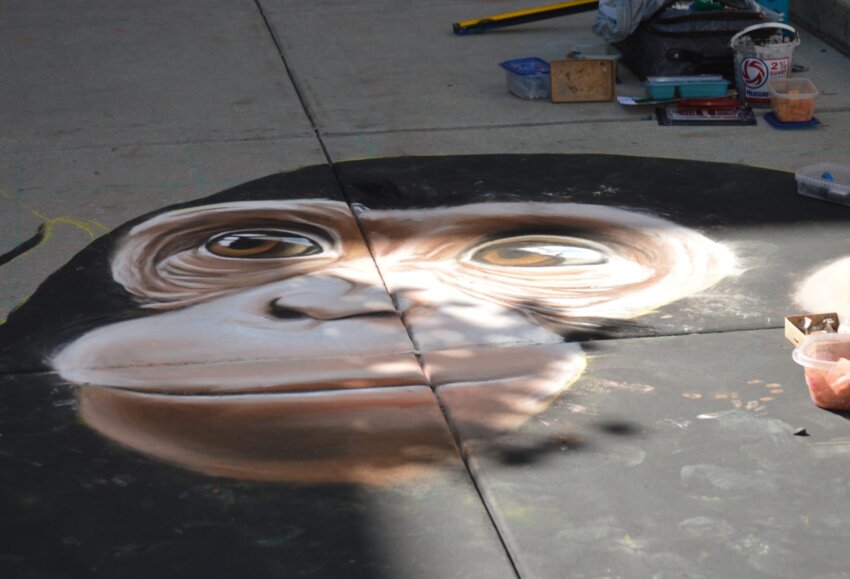 One of the chalk art pieces at the 2023 Centennial Chalk Art Festival was of a monkey’s face, created by artist Noreen Schroder.